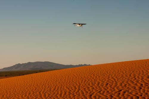Plane over dunes.jpg